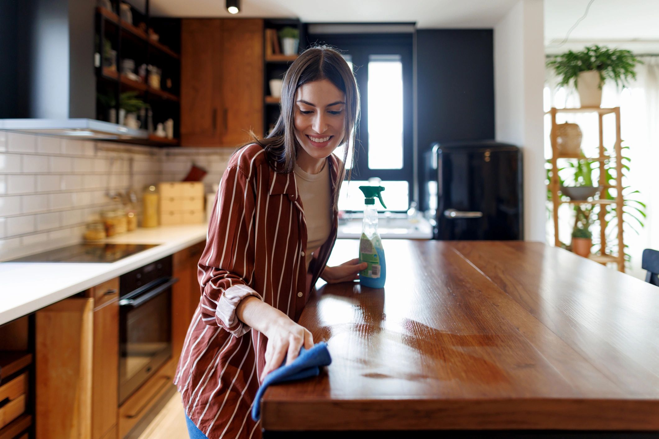 Professional cleaner wiping a kitchen countertop